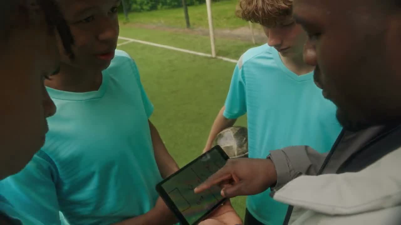 A coach talking to a youth team